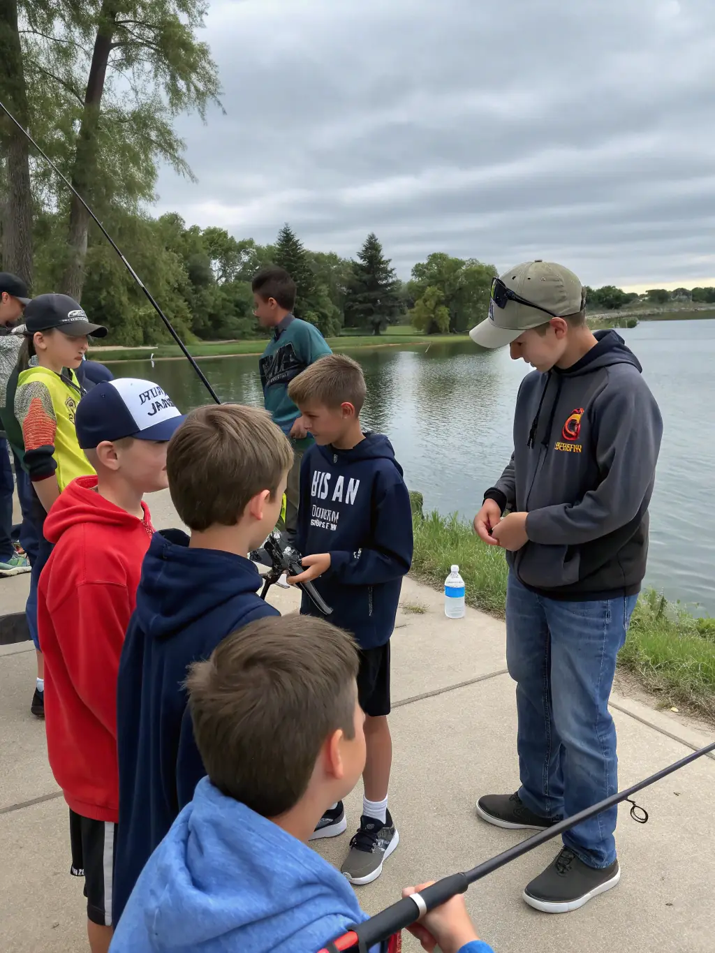 A photograph capturing a group of children participating in a fishing workshop at the Vignes Pond, demonstrating the association's commitment to educating the younger generation about sustainable fishing practices.